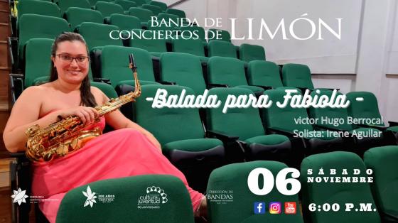 Concierto Especial “Día Internacional del Saxofón” – Estreno de "Balada para Fabiola" - Banda de Conciertos de Limón. Foto de Irene Aguilar saxofonista con un vestido rosa entre butacas verdes.