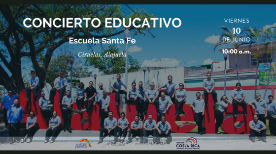 Concierto Educativo en la Escuela Santa Fe - Banda de Conciertos de Alajuela Músicos de la Banda de Alajuela en parque junto a letras rojas de ALAJUELA