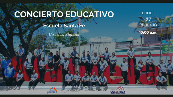 Concierto Educativo en Escuela Santa Fe, Ciruelas - Banda de Conciertos de Alajuela Músicos de la Banda de Alajuela en parque junto a letras rojas de ALAJUELA