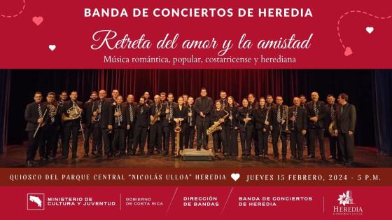 Concierto "Retreta del Amor y la Amistad" | Banda de Conciertos de Heredia Foto de la Banda de Conciertos de Heredia sobre un escenario con fondo rojo y letras blancas rodeadas de corazones